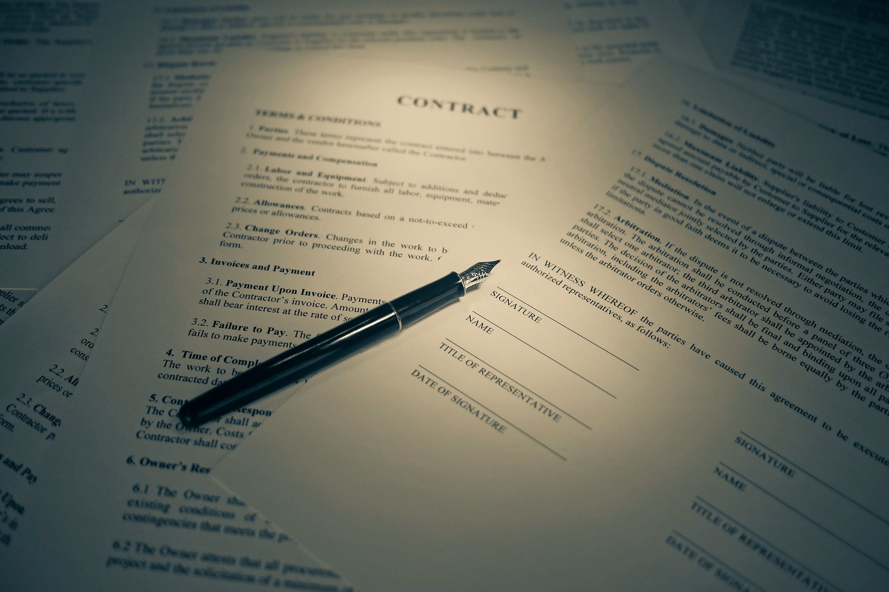 A contract and a fountain pen, ready for signature